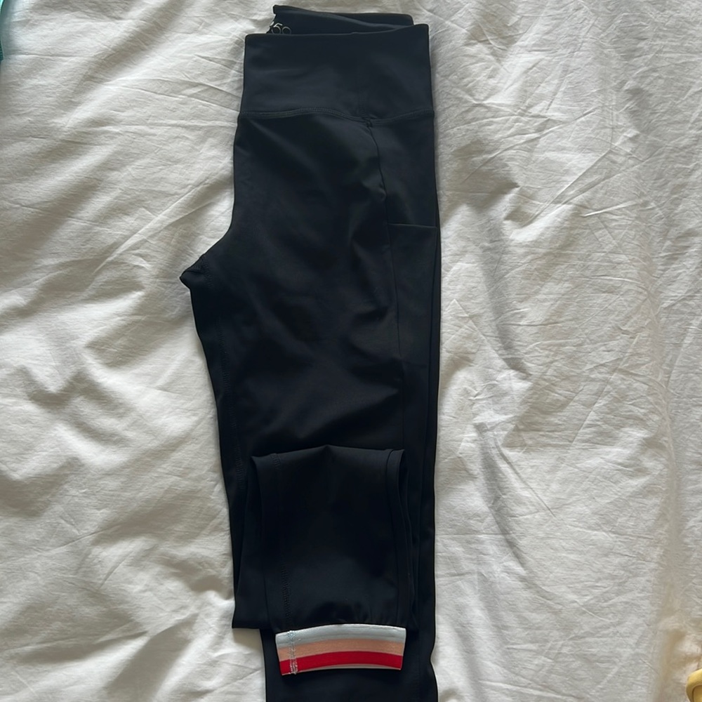 Splits59 black leggings with pockets and red, pink, white striped band. Size M